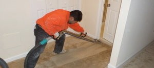 Water Damage Restoration Tech Cleaning Carpet